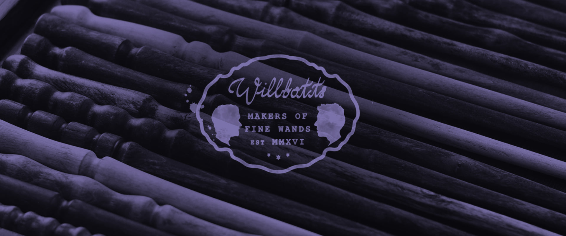 wooden wands form a background to the Wilbott's Wands logo