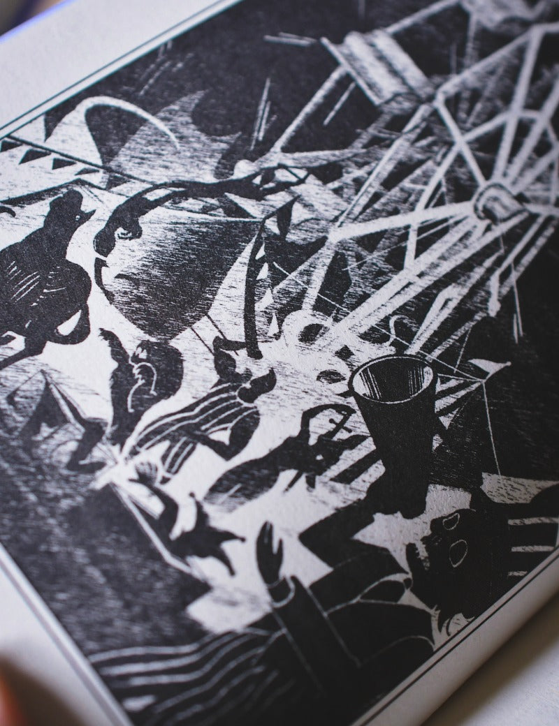 A close-up of a black and white linocut or woodcut print depicting a circus scene with animals and a ringmaster, photographed at an angle.